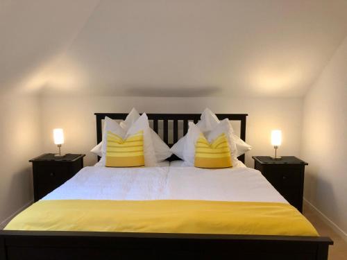 a bedroom with a large bed with yellow and white pillows at Apartment in Uni- und Citynähe in Oldenburg