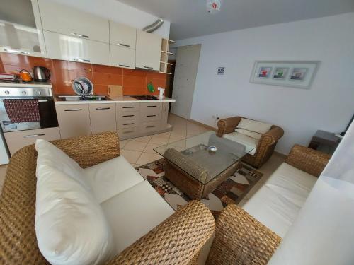a living room with a couch and a table at Bral Apartments 4 in Durrës