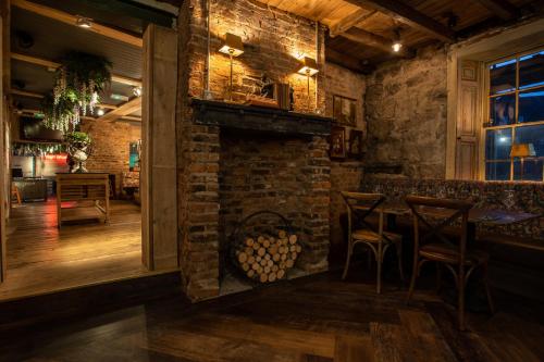 a bar with a brick fireplace in a restaurant at Crux in Alnwick