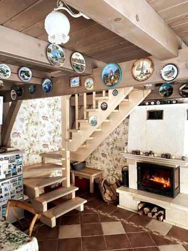 a living room with a staircase and a fireplace at Estere in Cēsis