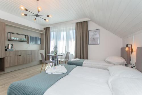 Кровать или кровати в номере Pokoje Gościnne Krzyś