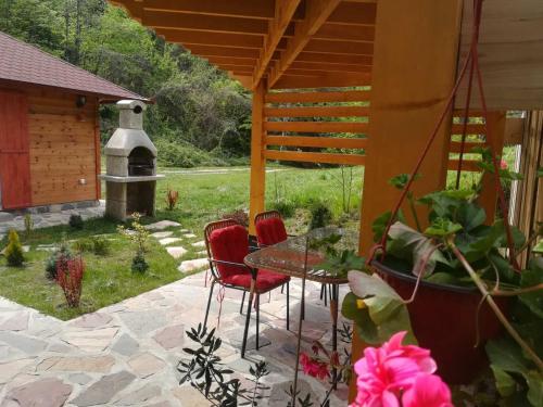 a patio with a table and chairs and a fountain at Brvnara kraj Dunava Zelena Oaza in Banoštor