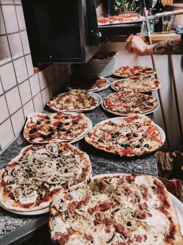 a bunch of pizzas sitting on a counter at Mountain Hostel Gimmelwald in Gimmelwald