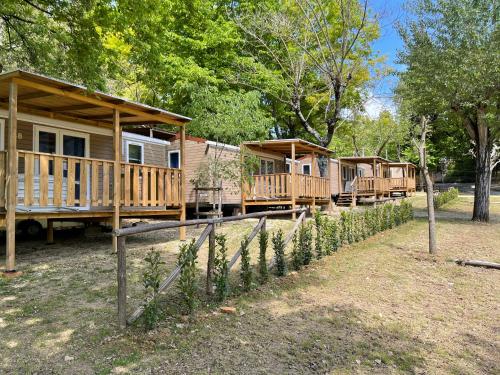 a row of wooden cabins in a park at Camping Siena Colleverde in Siena