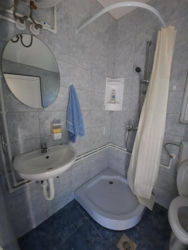 a bathroom with a toilet and a sink and a mirror at Apartmani Milojić in Soko Banja