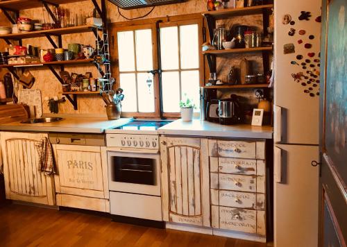 a kitchen with a stove and a refrigerator at Breitmoos in Hasliberg