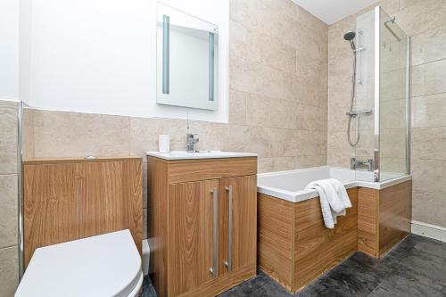 a bathroom with a toilet and a sink and a shower at Tower View in Chester
