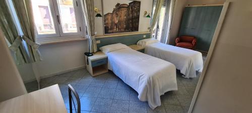 a hospital room with two beds and a table at Hotel Ferrucci in Turin