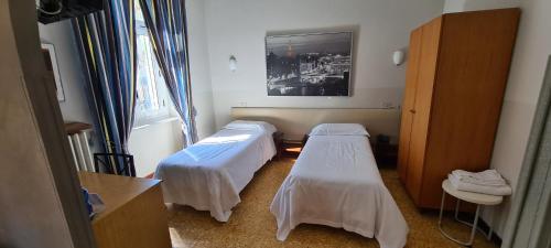 a hospital room with two beds and a window at Hotel Ferrucci in Turin