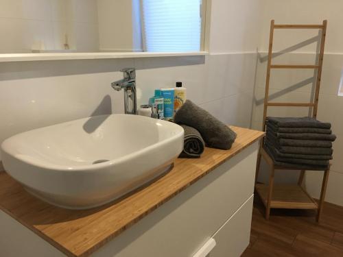 a bathroom with a white sink on a wooden counter at Kopalnia Wspomnień in Kopalino