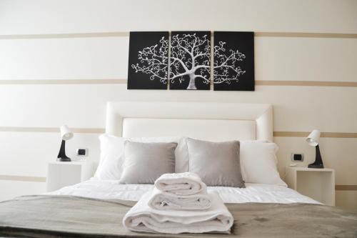 a bedroom with a bed with a tree painting on the wall at MR Living Bed & Breakfast in Boiano