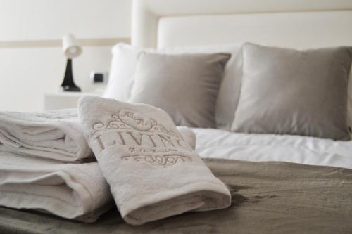 a bed with towels and pillows on it at MR Living Bed & Breakfast in Boiano