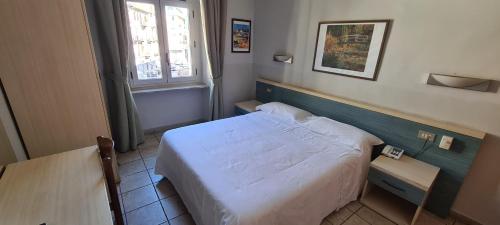 a small bedroom with a bed and a table at Hotel Ferrucci in Turin