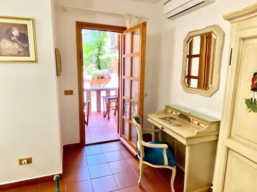 ein Heimbüro mit einem Schreibtisch und Blick auf einen Innenhof in der Unterkunft Hotel Grazia Deledda in Arzachena