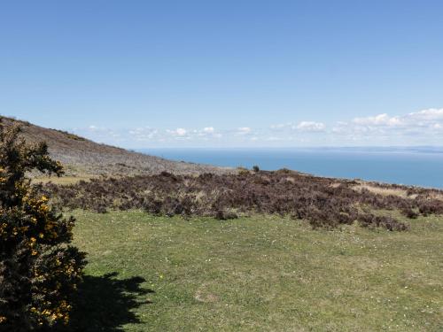 a hill with the ocean in the background at Small Piece in Minehead