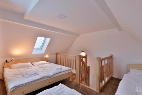 a bedroom with two twin beds and a window at Apartmány Na handě in Boží Dar