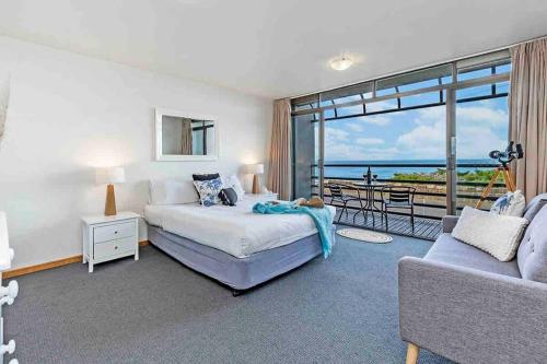 a bedroom with a bed and a couch at Oceanscape ~ OCEAN VIEWS Uninterrupted in Portland