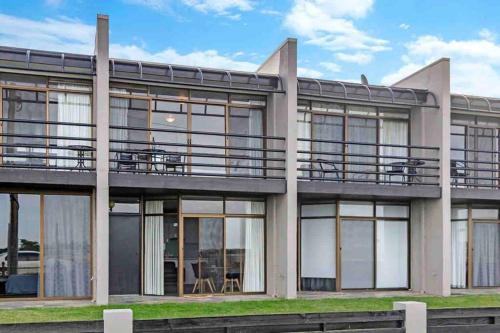 a building with large windows and a balcony at Oceanscape ~ OCEAN VIEWS Uninterrupted in Portland