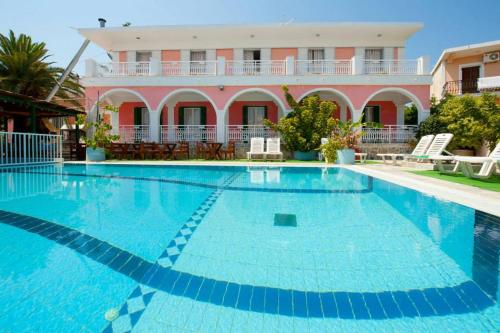 a large swimming pool in front of a building at Stella Studios in Argasi
