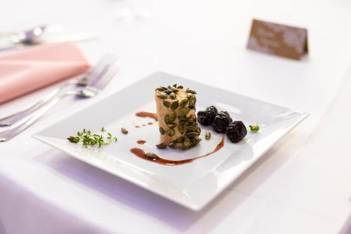 a white plate with a dessert on a table at Vegas Hriňová Penzión in Hriňová