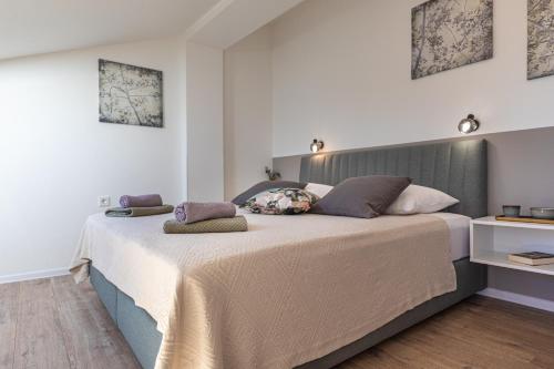 a bedroom with a large bed with two pillows on it at Pansion Tina in Šilo