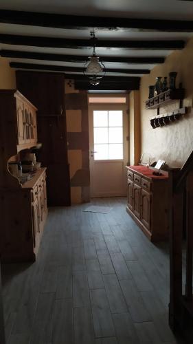 a large room with a kitchen with a window at La Grange de Champagnac in Yvrac-et-Malleyrand