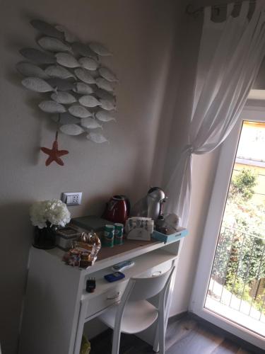 a white desk in a room with a window at Le Storie di Manarola in Manarola