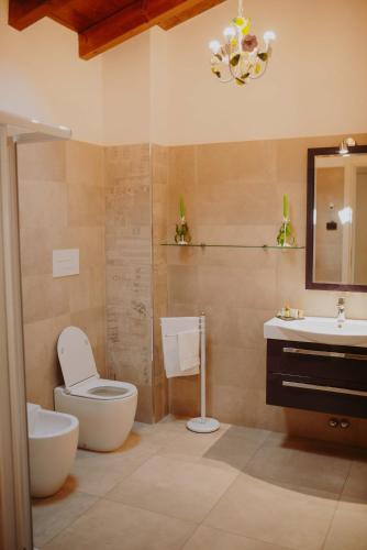 a bathroom with a toilet and a sink and a mirror at B&B Casa Santa Lucia in Manerba del Garda