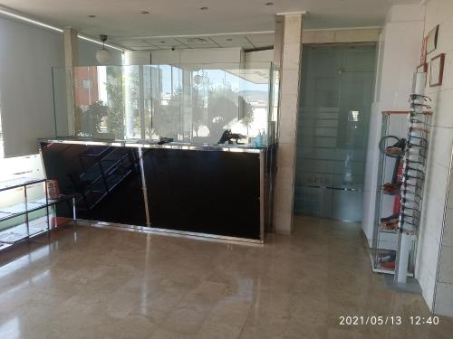 a large room with a counter and a glass wall at Olimpia Hoteles in Totana