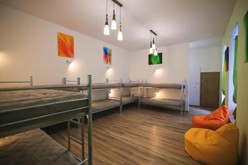 a room with two bunk beds and a couch at Viva la Vida Hostel in Braşov