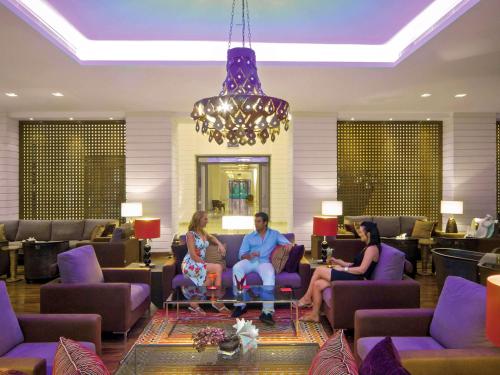 a group of people sitting in a waiting room at Mövenpick Resort & Spa Tala Bay Aqaba in Aqaba
