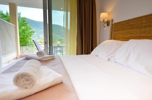 a hotel room with a bed with towels on it at Meltemi Studios in Vasiliki