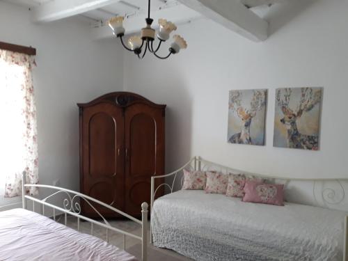 um quarto com uma cama e um lustre em Szép Julis Vendégház em Cserépfalu