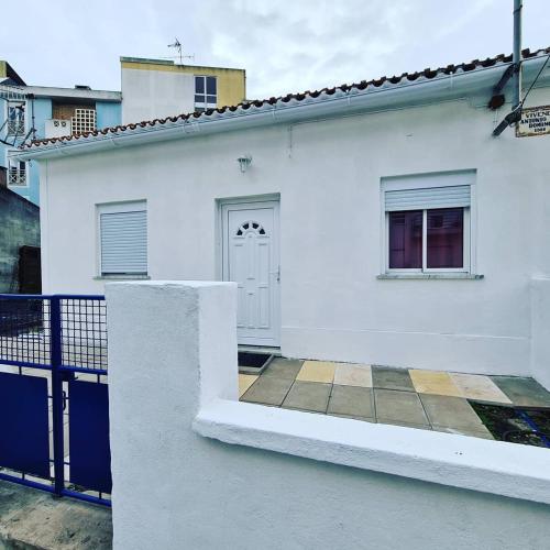 une maison blanche avec une porte et une clôture dans l'établissement Caldas Relax & Leisure, à Caldas da Rainha