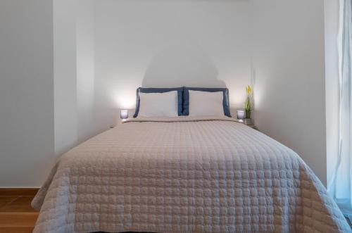 a bed with two pillows on it in a bedroom at Apartments Garden Azure Budva in Budva