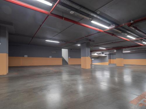 an empty parking garage with a large room with a unintention at Apartments Garden Azure Budva in Budva