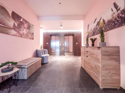 a living room with a couch and a table at Apartments Garden Azure Budva in Budva
