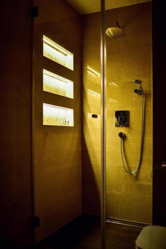a bathroom with a shower with a glass door at Aurora & Tramonto in Zadar