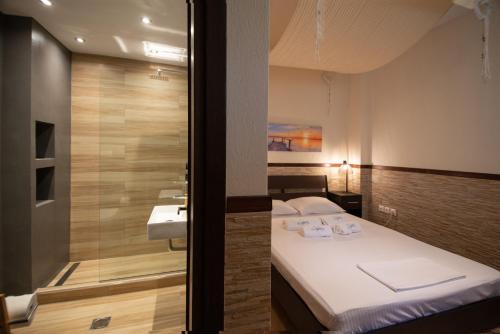 Voodi või voodid majutusasutuse Sybaris Privacy and Luxury toas