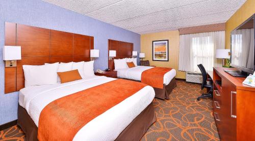 a hotel room with two beds and a television at Best Western Plus Fresno Airport Hotel in Fresno