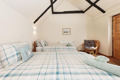 a bedroom with a large bed and a chair at Beachborough Park in Folkestone