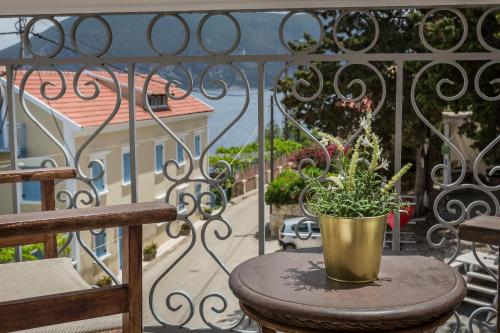 a potted plant sitting on a table on a balcony at Faros Suites (Adults Only) in Fiskardho