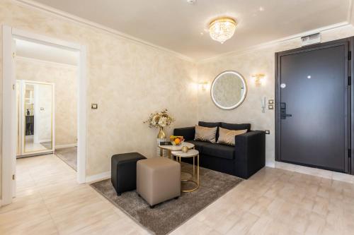 a living room with a couch and a table at Onyx Beach Residence - Free Parking & Beach Access in Sveti Vlas