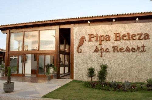 a building with a sign on the side of it at Pipa Beleza Spa Resort in Pipa