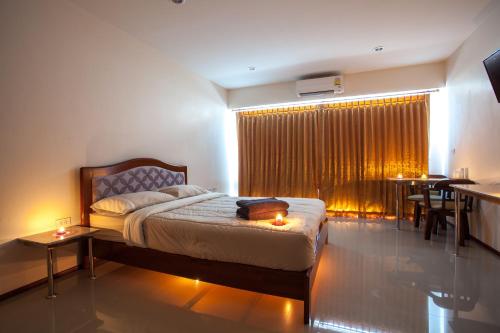 1 dormitorio con cama, mesa y ventana en Dream Boutique Hotel, en Cha Am