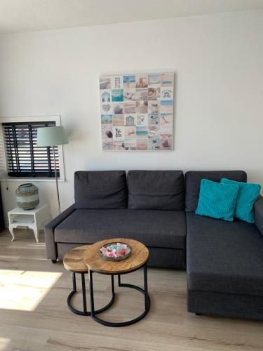 a living room with a couch and a table at Beach House Zandvoort in Zandvoort