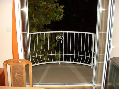 an open door to a balcony with a gate at Vila Fontana - Sobe in Bela Crkva