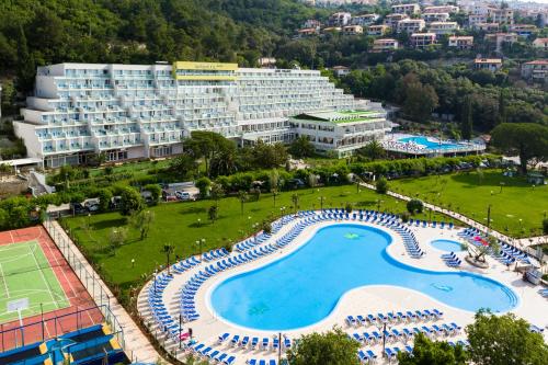 an aerial view of a resort with a large swimming pool at Hotel Mimosa Lido Palace - Maslinica Hotels & Resorts in Rabac