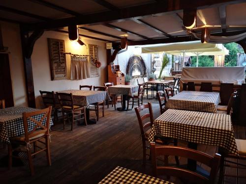 a restaurant with tables and chairs in a room at Apartments Vila Apolonia in Ljubljana