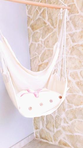 a white hammock hanging from a stone wall at Skalinada in Vir